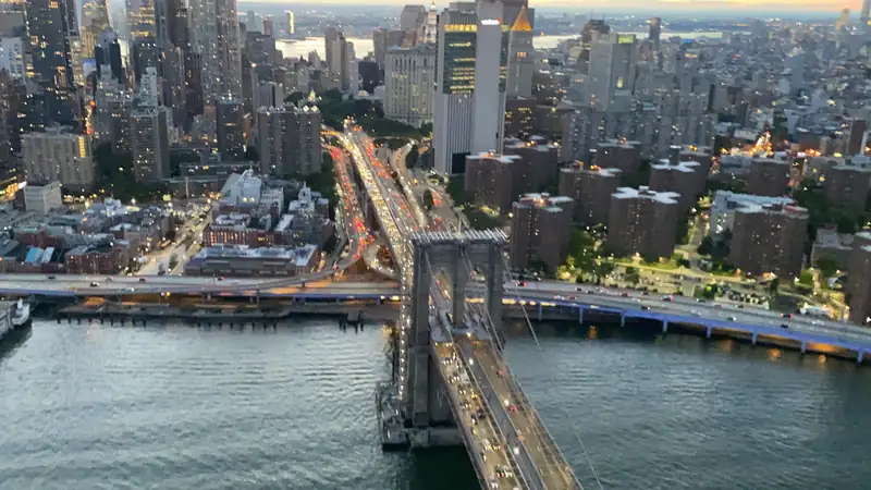 Brooklyn Bridge traffic and the Lower East Side from above at dusk