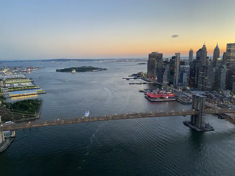 The Brooklyn Bridge and Lower Manhattan at dusk, seen from above