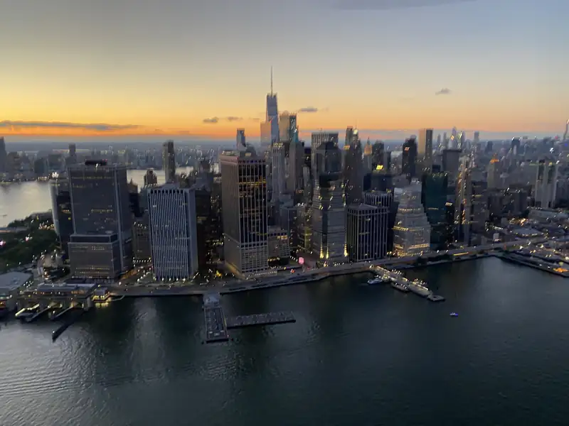 Lower Manhattan and the harbor at sunset, seen from above