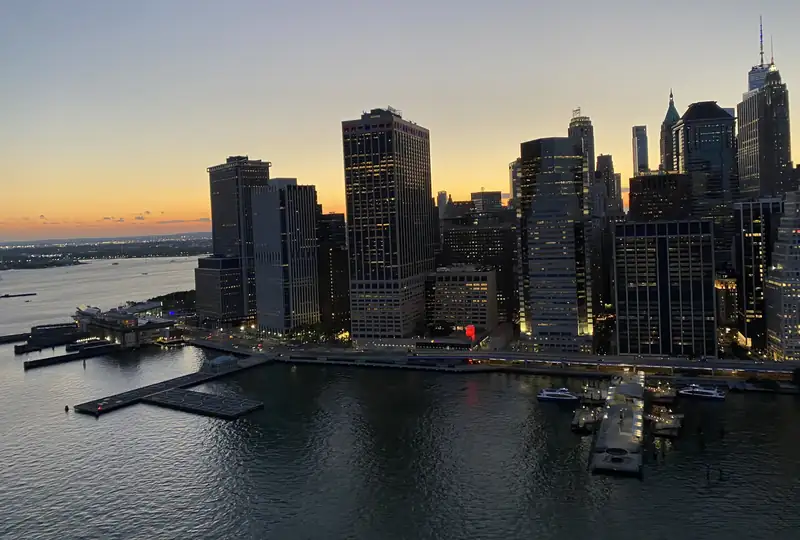Lower Manhattan waterfront towers at dusk