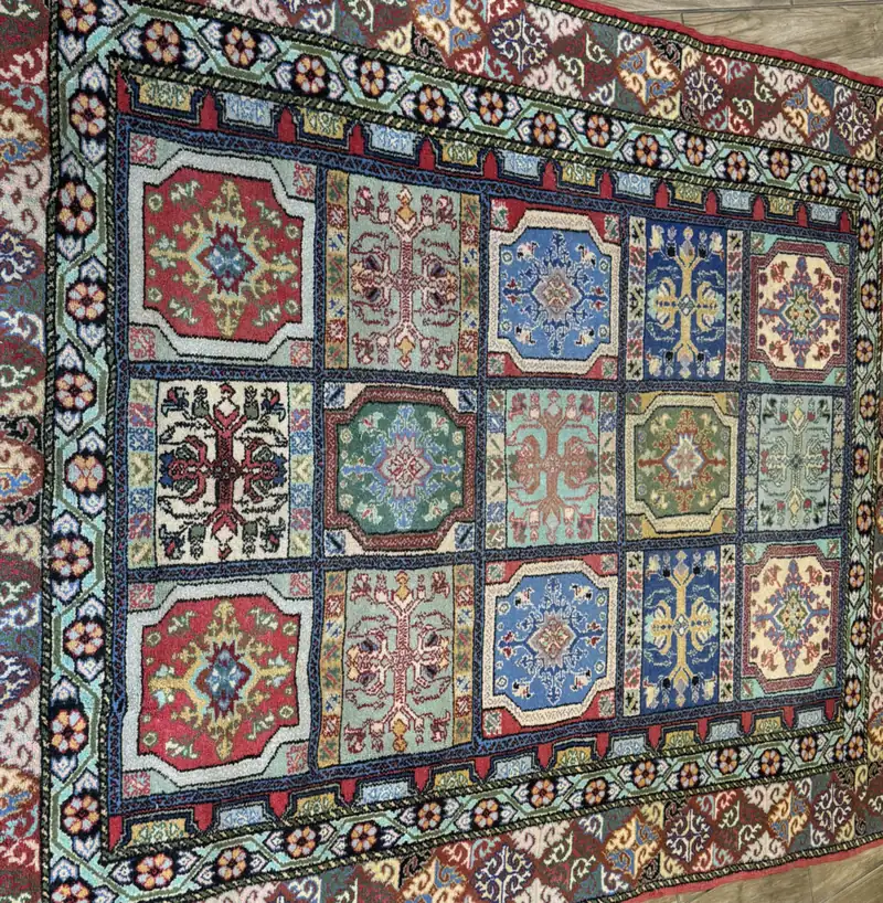 Close view of the colored garden panels of a rug