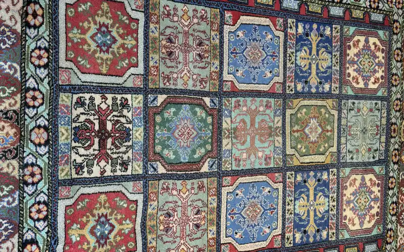 Close view of the colored garden panels of a rug